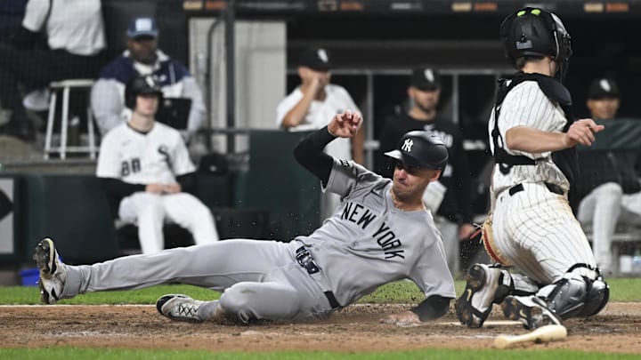 New York Yankees outfielder Cody Bellinger (35) slides safely past Chicago White Sox catcher Kyle Teel (8) at Rate Field. 