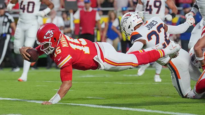 Kansas City Chiefs quarterback Patrick Mahomes (15) scores on Denver Broncos cornerback Brandon Jones (22) during game at Arrowhead Stadium. Kansas City Chiefs quarterback Patrick Mahomes (15) scores on Denver Broncos cornerback Brandon Jones (22) during game at Arrowhead Stadium.
