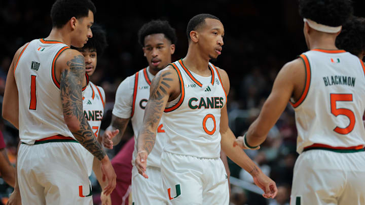 Jan 8, 2025; Coral Gables, Florida, USA; Miami Hurricanes guard Matthew Cleveland (0) high-fives with teammates against the Florida State Seminoles during the second half at Watsco Center. Mandatory Credit: Sam Navarro-Imagn Images Jan 8, 2025; Coral Gables, Florida, USA; Miami Hurricanes guard Matthew Cleveland (0) high-fives with teammates against the Florida State Seminoles during the second half at Watsco Center. Mandatory Credit: Sam Navarro-Imagn Images