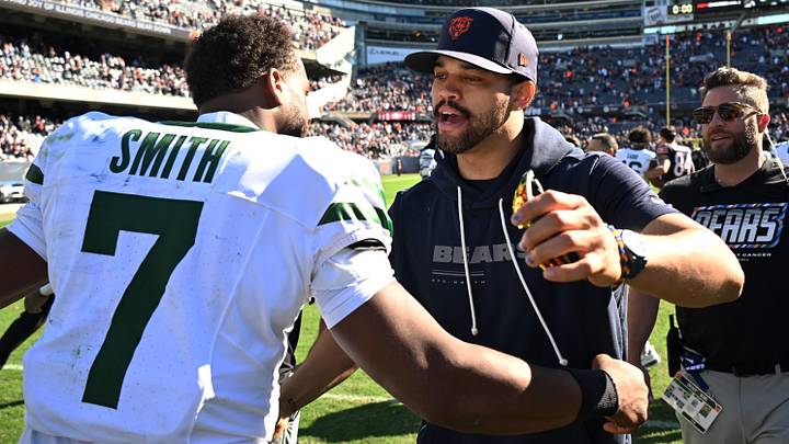Chicago Bears quarterback Caleb Williams (18) hugs New York Jets quarterback Geno Smith (7) after the game at Soldier Field.  Mandatory Credit: Matt Marton-Imagn Images