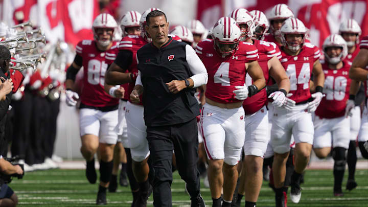 Sep 20, 2025; Madison, Wisconsin, USA;  Wisconsin Badgers head coach Luke Fickell runs onto the field ahead of players prior to the game against the Maryland Terrapins at Camp Randall Stadium.
