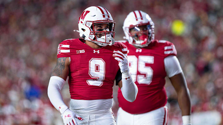 Oct 11, 2025; Madison, Wisconsin, USA; Wisconsin Badgers safety Austin Brown (9) and defensive lineman Brandon Lane Jr. (95) look at the scoreboard in the second half against the Iowa Hawkeyes at Camp Randall Stadium. Mandatory Credit: Ross Harried-Imagn Images