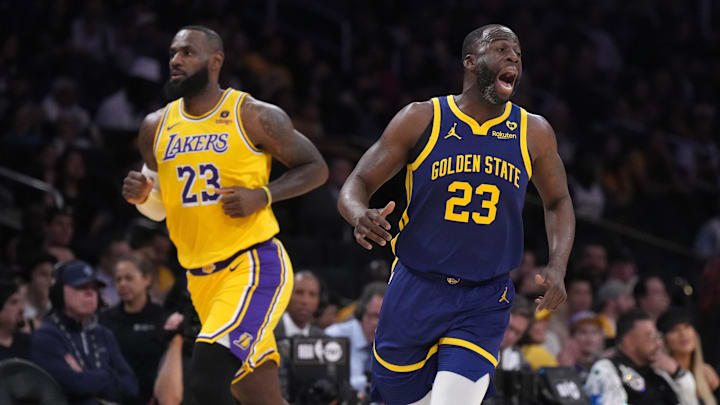 Apr 9, 2024; Los Angeles, California, USA; Golden State Warriors forward Draymond Green (right) and Los Angeles Lakers forward LeBron James react in the first half at Crypto.com Arena. Mandatory Credit: Kirby Lee-Imagn Images