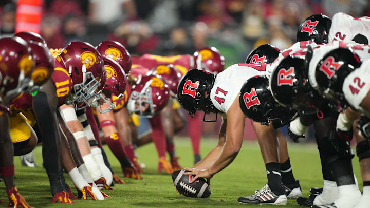 Oct 25, 2024; Los Angeles, California, USA; Helmets at the line of scrimmage as Rutgers Scarlet Knights long snapper Austin Riggs (47) snaps the ball against the Southern California Trojans in the first half at United Airlines Field at Los Angeles Memorial Coliseum. 