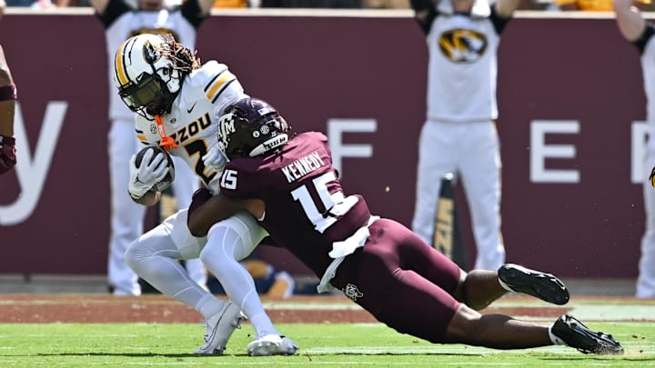 Oct 5, 2024; College Station, Texas, USA; Texas A&M Aggies defensive lineman Rylan Kennedy (15) tackles Missouri Tigers wide receiver Marquis Johnson (2) in the third quarter at Kyle Field. Mandatory Credit: Maria Lysaker-Imagn Images. 