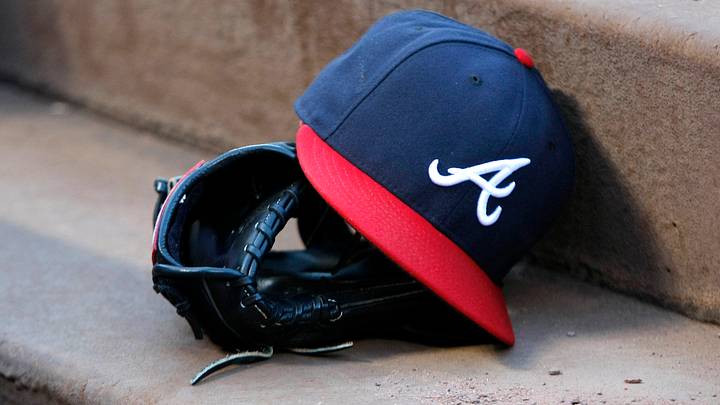 Aug 25, 2015; Atlanta, GA, USA; Detailed view of Atlanta Braves hat and glove in the dugout before a game against the Colorado Rockies at Turner Field. Mandatory Credit: Brett Davis-USA TODAY Sports