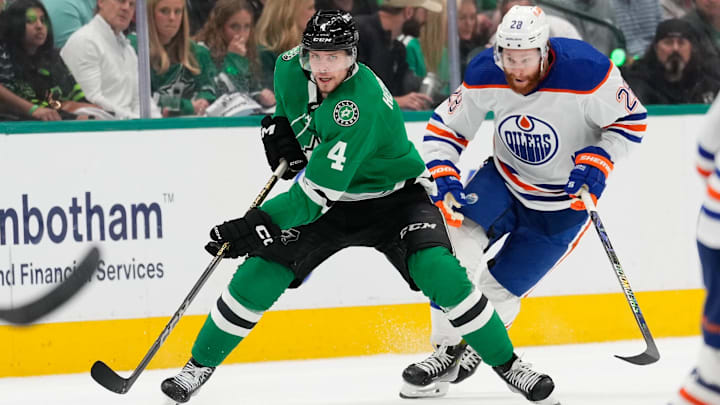May 31, 2024; Dallas, Texas, USA; Dallas Stars defenseman Miro Heiskanen (4) skates with the puck ahead of Edmonton Oilers right wing Connor Brown (28) during the second period between the Dallas Stars and the Edmonton Oilers in game five of the Western Conference Final of the 2024 Stanley Cup Playoffs at American Airlines Center. Mandatory Credit: Chris Jones-Imagn Images
