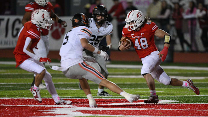 Joshua Bladel #48 of the Moon Tigers carries the ball in the first half during the game against the Bethel Park Black Hawks at Tiger Stadium on Friday Night in Moon Township, Pennsylvania.