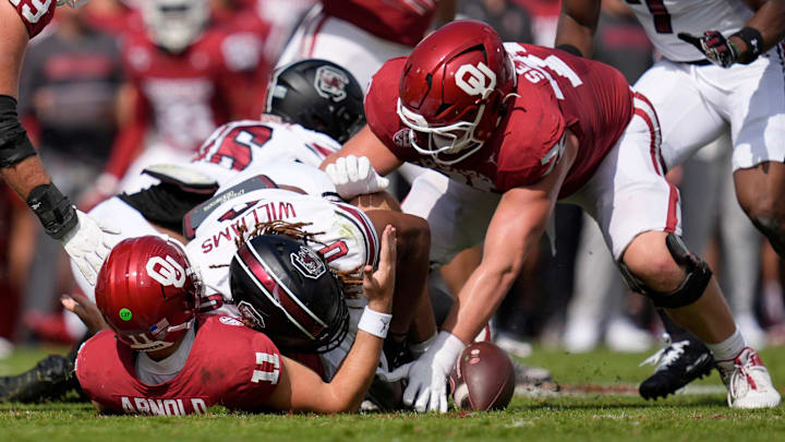 Oklahoma Sooners quarterback Jackson Arnold (11) fumbles the ball as he is hit by South Carolina Gamecocks linebacker Debo Williams (0) during a college football game between the University of Oklahoma Sooners (OU) and the South Carolina Gamecocks at Gaylord Family - Oklahoma Memorial Stadium in Norman, Okla., Saturday, Oct. 19, 2024. Oklahoma recovered the fumble on the play.
