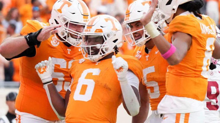 Tennessee offensive lineman Cooper Mays (63), wide receiver Bru McCoy (5), and quarterback Nico Iamaleava (8) surround running back Dylan Sampson (6) in celebration after Sampson's touchdown during an NCAA college football game against Alabama on Saturday, Oct. 19, 2024, in Knoxville. Tenn.