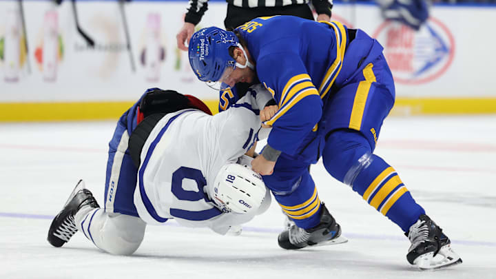 Mar 14, 2026; Buffalo, New York, USA;  Buffalo Sabres defenseman Luke Schenn (5) and Toronto Maple Leafs center Dakota Joshua (81) fight during the first period at KeyBank Center. Mandatory Credit: Timothy T. Ludwig-Imagn Images
