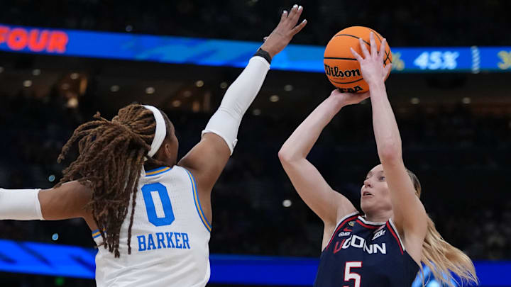 Apr 4, 2025; Tampa, FL, USA;  Connecticut Huskies guard Paige Bueckers (5) shoots against UCLA Bruins forward Janiah Barker (0) during second quarter in a semifinal of the women's 2025 NCAA tournament at Amalie Arena. Mandatory Credit: Kirby Lee-Imagn Images