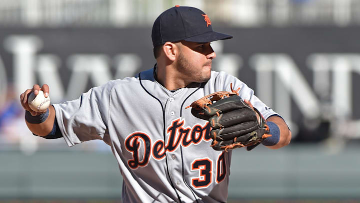 Sep 21, 2014; Kansas City, MO, USA; Detroit Tigers shortstop Eugenio Suarez (30) turns to make a throw to first against the Kansas City Royals during the eighth inning at Kauffman Stadium. Mandatory Credit: Peter G. Aiken-Imagn Images