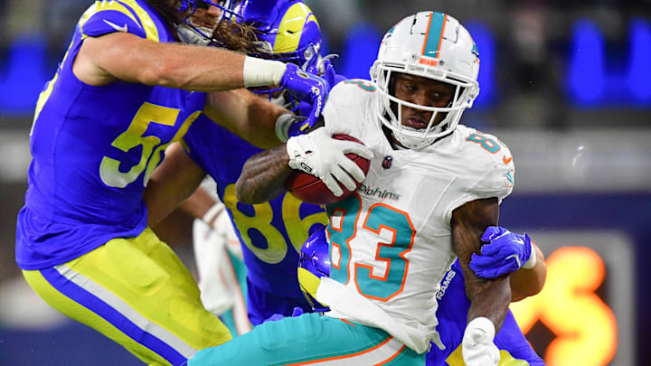 Nov 11, 2024; Inglewood, California, USA; Miami Dolphins cornerback Siran Neal (33) is brought down by Los Angeles Rams linebacker Christian Rozeboom (56) during the first half at SoFi Stadium. Mandatory Credit: Gary A. Vasquez-Imagn Images