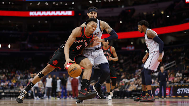 Jan 29, 2025; Washington, District of Columbia, USA; Toronto Raptors forward Scottie Barnes (4) drives to the basket as Washington Wizards forward Kyle Kuzma (33) defends in the third quarter at Capital One Arena. Mandatory Credit: Geoff Burke-Imagn Images