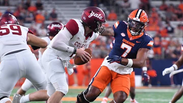 Sep 2, 2023; Syracuse, New York, USA; Colgate Raiders quarterback Zach Osborne (1) is pressured by Syracuse linebacker Stefon Thompson (7).