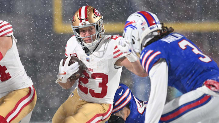 Dec 1, 2024; Orchard Park, New York, USA; San Francisco 49ers running back Christian McCaffrey (23) tries to avoid Buffalo Bills safety Damar Hamlin (3) on a run in the first quarter at Highmark Stadium. Mandatory Credit: Mark Konezny-Imagn Images
