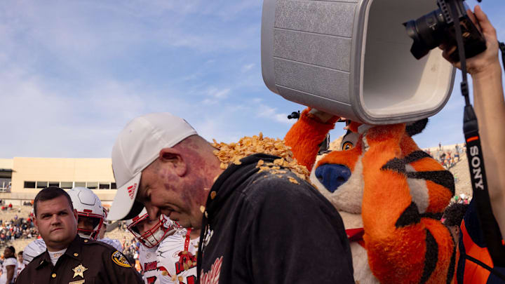Tony the Tiger tosses corn flakes on Louisville head coach Jeff Brohm after the Cardinals won the Tony the Tiger Sun Bowl 