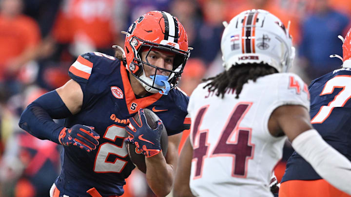 Nov 2, 2024; Syracuse, New York, USA; Syracuse Orange wide receiver Trebor Pena (2) tries to avoid a tackle by Virginia Tech Hokies cornerback Dorian Strong (44) in the third quarter at JMA Wireless Dome. Mandatory Credit: Mark Konezny-Imagn Images