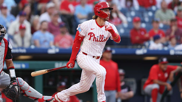 Apr 30, 2025; Philadelphia, Pennsylvania, USA; Philadelphia Phillies second base Bryson Stott (5) hits a single against the Washington Nationals during the first inning at Citizens Bank Park.