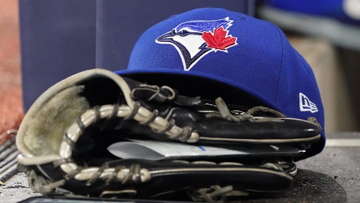 A Toronto Blue Jays cap and glove sits in the dugout during a game against the Arizona Diamondbacks at Rogers Centre.