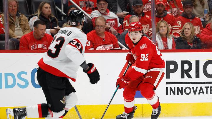 Mar 24, 2026; Detroit, Michigan, USA;  Detroit Red Wings center Marco Kasper (92) skates with the puck defended by Ottawa Senators defenseman Nikolas Matinpalo (33) in the second period at Little Caesars Arena. Mandatory Credit: Rick Osentoski-Imagn Images