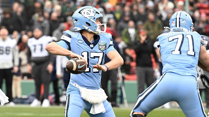 Dec 28, 2024; Boston, MA, USA; North Carolina Tar Heels quarterback Michael Merdinger (17) throws a pass against the Connecticut Huskies during the first half at Fenway Park. Mandatory Credit: Eric Canha-Imagn Images