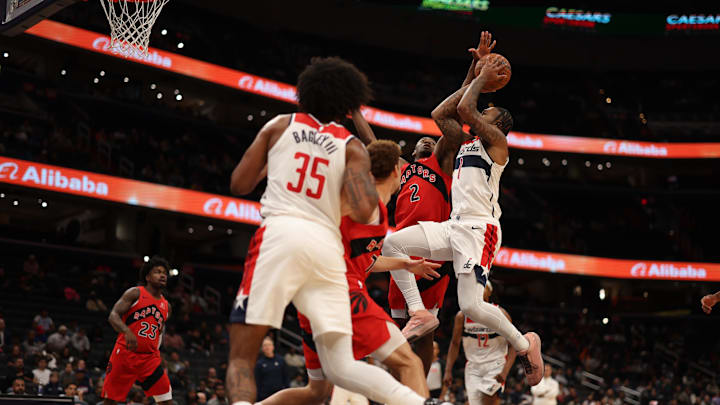 Oct 12, 2025; Washington, District of Columbia, USA; Washington Wizards forward Cam Whitmore (1) is fouled while shooting by Toronto Raptors forward Jonathan Mogbo (2) in the second half at Capital One Arena. Mandatory Credit: Geoff Burke-Imagn Images