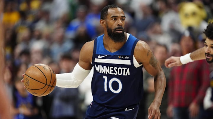 Mar 12, 2025; Denver, Colorado, USA; Minnesota Timberwolves guard Mike Conley (10) controls the ball in the first quarter against the Denver Nuggets at Ball Arena.