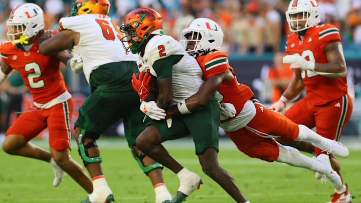 Sep 7, 2024; Miami Gardens, Florida, USA; Florida A&M Rattlers wide receiver Jamari Gassett (2) runs with the football against Miami Hurricanes defensive back Zaquan Patterson (20) during the second quarter at Hard Rock Stadium. Mandatory Credit: Sam Navarro-Imagn Images Sep 7, 2024; Miami Gardens, Florida, USA; Florida A&M Rattlers wide receiver Jamari Gassett (2) runs with the football against Miami Hurricanes defensive back Zaquan Patterson (20) during the second quarter at Hard Rock Stadium. Mandatory Credit: Sam Navarro-Imagn Images
