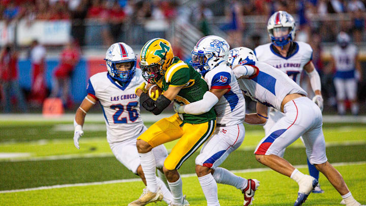 Mayfield Trojan Zaiden Salcido runs the ball during a high school football game at the Field of Dreams.