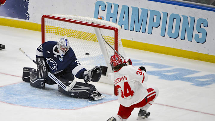 Boston University Terriers forward Cole Eiserman shoots and scores against Penn State goaltender Arsenii Sergeev during the second period of the Frozen Four college ice hockey national semifinals at Enterprise Center.