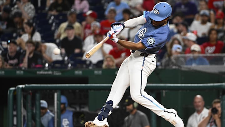 Jun 13, 2025; Washington, District of Columbia, USA; Washington Nationals third baseman Jose Tena (8) singles against the Miami Marlins during the sixth inning at Nationals Park.