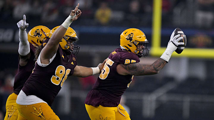 Dec 7, 2024; Arlington, TX, USA; Arizona State Sun Devils defensive lineman Anthonie Cooper (96) and defensive lineman Justin Wodtly (95) celebrate after Wodtly recovers a Iowa State Cyclones fumble during the second half at AT&T Stadium. Mandatory Credit: Jerome Miron-Imagn Images