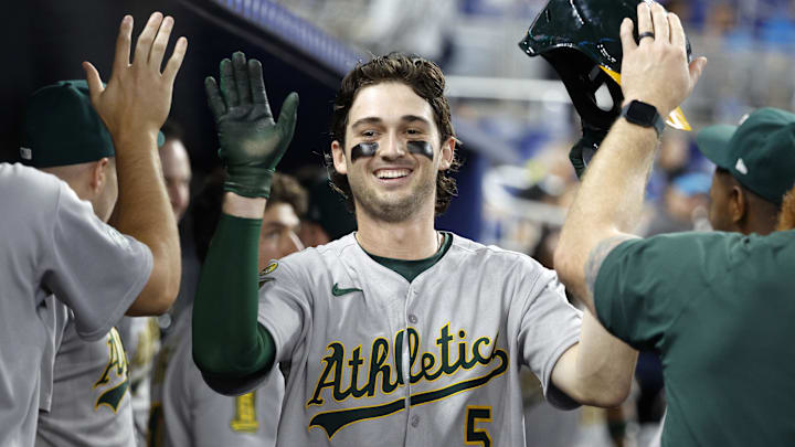 May 4, 2025; Miami, Florida, USA;  Oakland Athletics shortstop Jacob Wilson (5) is greeted in the dugout by teammates after scoring against the Miami Marlins during the second inning at loanDepot Park. Mandatory Credit: Rhona Wise-Imagn Images