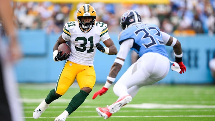 Sep 22, 2024; Nashville, Tennessee, USA; Tennessee Titans safety Jamal Adams (33) tackles Green Bay Packers running back Emanuel Wilson (31) during the first half at Nissan Stadium. Sep 22, 2024; Nashville, Tennessee, USA; Tennessee Titans safety Jamal Adams (33) tackles Green Bay Packers running back Emanuel Wilson (31) during the first half at Nissan Stadium.