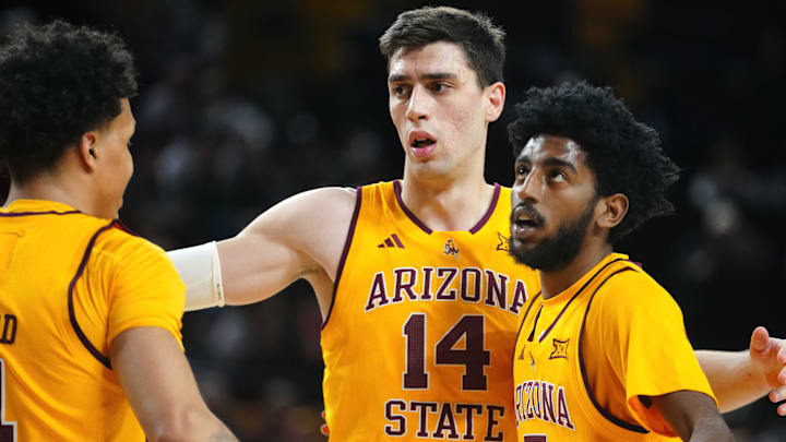 Arizona State forward Andrija Grbović (14) gathers Bryce Ford (4) and Moe Odum (5) during a game against Cincinnati at Desert Financial Arena in Tempe, Ariz., on Jan. 24, 2026.