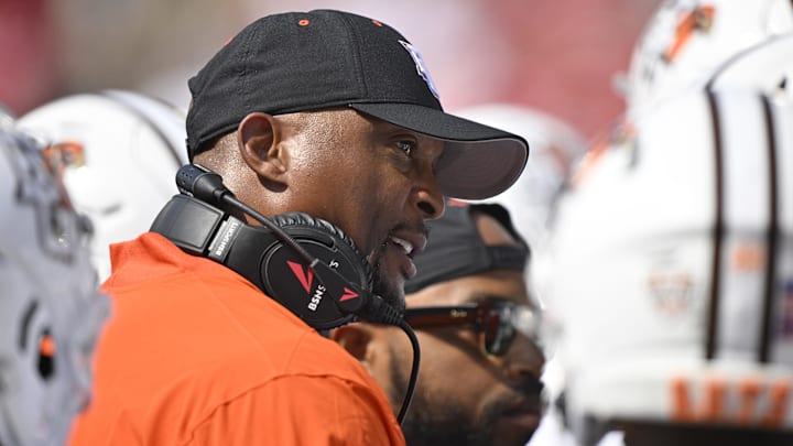 Eddie George talks with his players during the first quarter against the Louisville Cardinals. 