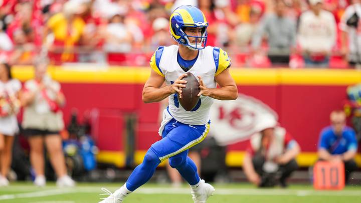 Aug 15, 2026; Kansas City, Missouri, USA; Los Angeles Rams quarterback Stetson Bennett IV (13) rolls out to pass during the first half against the Kansas City Chiefs at Arrowhead Stadium. Mandatory Credit: Jay Biggerstaff-Imagn Images