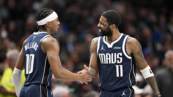 Feb 12, 2025; Dallas, Texas, USA; Dallas Mavericks guard Brandon Williams (10) and guard Kyrie Irving (11) celebrate after Irving scores against the Golden State Warriors during the second quarter at the American Airlines Center. Mandatory Credit: Jerome Miron-Imagn Images