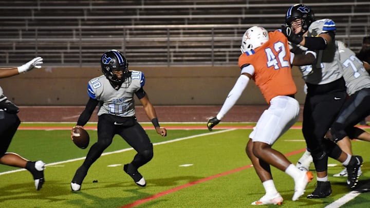 Lewisville Hebron quarterback Patrick Crayton Jr. looks for running room in a Class 6A Division II area game against Arlington Bowie. 
