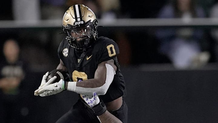 Kentucky defensive back Ty Bryant (14) tries to stop Vanderbilt wide receiver Junior Sherrill (0) after Sherrill caught a pass during the fourth quarter at FirstBank Stadium in Nashville, Tenn., Saturday, Nov. 22, 2025.