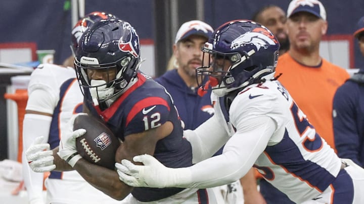 Dec 3, 2023; Houston, Texas, USA;Houston Texans wide receiver Nico Collins (12) is tackled b y Denver Broncos linebacker Baron Browning (56) in the second half at NRG Stadium. Dec 3, 2023; Houston, Texas, USA;Houston Texans wide receiver Nico Collins (12) is tackled b y Denver Broncos linebacker Baron Browning (56) in the second half at NRG Stadium.