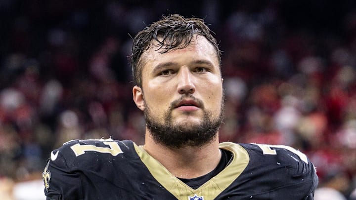 Sep 14, 2025; New Orleans, Louisiana, USA;  New Orleans Saints offensive tackle Dillon Radunz (77) heads off the field after the game against the San Francisco 49ers at Caesars Superdome. Mandatory Credit: Stephen Lew-Imagn Images