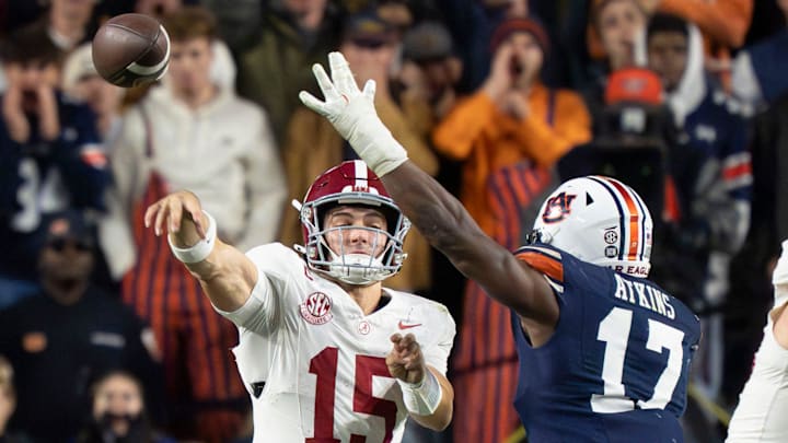 Alabama quarterback Ty Simpson (15) throws under pressure from Auburn linebacker Xavier Atkins (17)