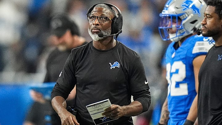 Detroit Lions defensive coordinator Aaron Glenn watches a replay during the first half of the loss to the Washington Commanders in the NFC divisional round of the NFL playoffs