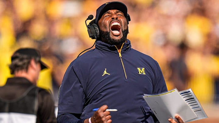 Michigan head coach Sherrone Moore cheers on before a play against Washington during the first half at Michigan Stadium in Ann Arbor on Saturday, Oct. 18, 2025. Michigan head coach Sherrone Moore cheers on before a play against Washington during the first half at Michigan Stadium in Ann Arbor on Saturday, Oct. 18, 2025.