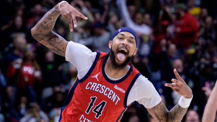 Feb 5, 2024; New Orleans, Louisiana, USA; New Orleans Pelicans forward Brandon Ingram (14) celebrates a three point basket against Toronto Raptors center Jakob Poeltl (19) during the second half at Smoothie King Center. Mandatory Credit: Matthew Hinton-USA TODAY Sports