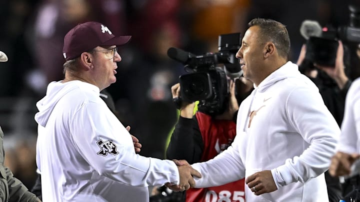 Nov 30, 2024; College Station, Texas, USA; Texas A&M Aggies head coach Mike Elko, left, shakes hands with Texas Longhorns head coach Steve Sarkisian after the game. The Longhorns defeated the Aggies 17-7. at Kyle Field. Mandatory Credit: Maria Lysaker-Imagn Images Nov 30, 2024; College Station, Texas, USA; Texas A&M Aggies head coach Mike Elko, left, shakes hands with Texas Longhorns head coach Steve Sarkisian after the game. The Longhorns defeated the Aggies 17-7. at Kyle Field. Mandatory Credit: Maria Lysaker-Imagn Images