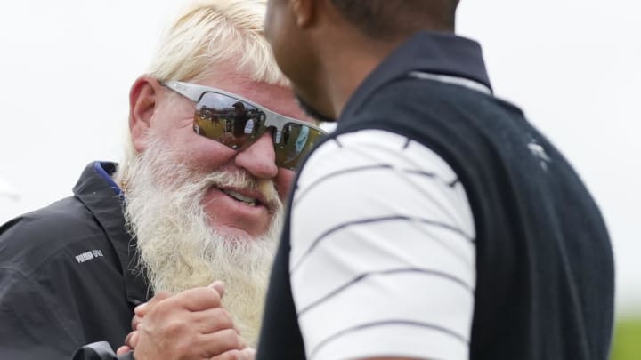 Tiger Woods hugs John Daly during a practice round for the PGA Championship golf tournament at Valhalla Golf Club. Tiger Woods hugs John Daly during a practice round for the PGA Championship golf tournament at Valhalla Golf Club.